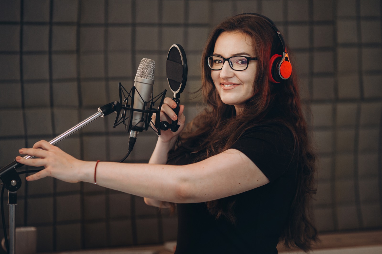 An AVA actor recording at a home studio setup